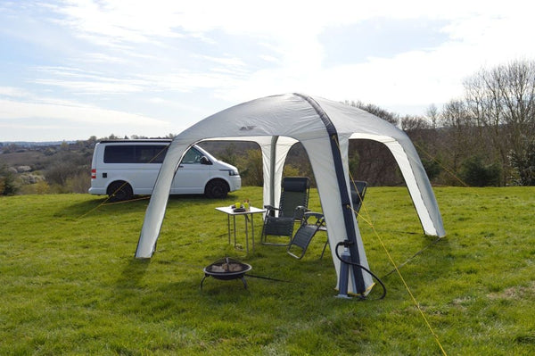 Maypole event shelter gazebo set up with camping chairs in the shade on a sunny day