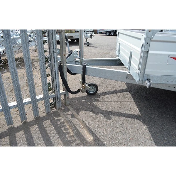 Caravan trailer hitch secured with a padlock and chain attached to a railing for security
