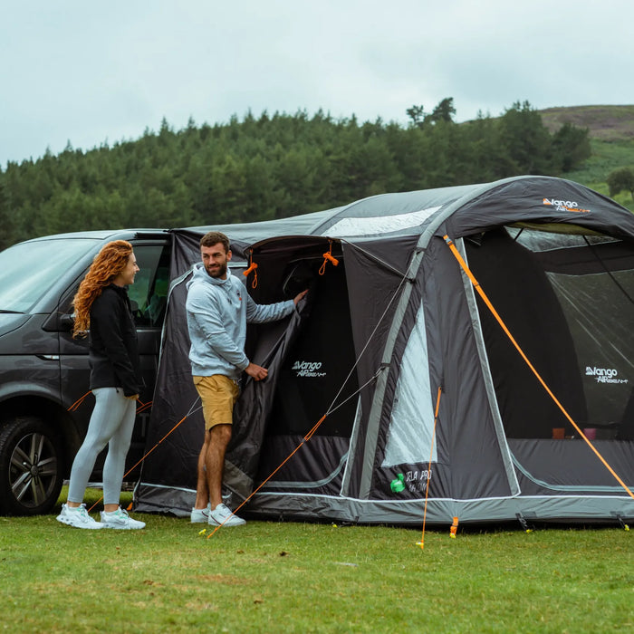 Vango Kela V Air Pro drive-away awning with a family around a campervan in sunshine