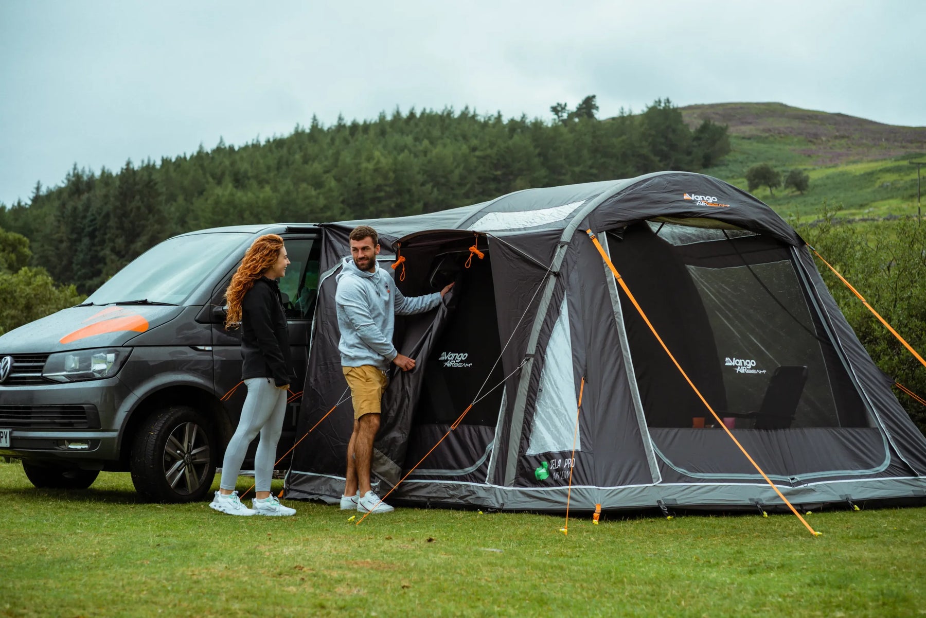 Vango Kela V Air Pro drive-away awning with a family around a campervan in sunshine