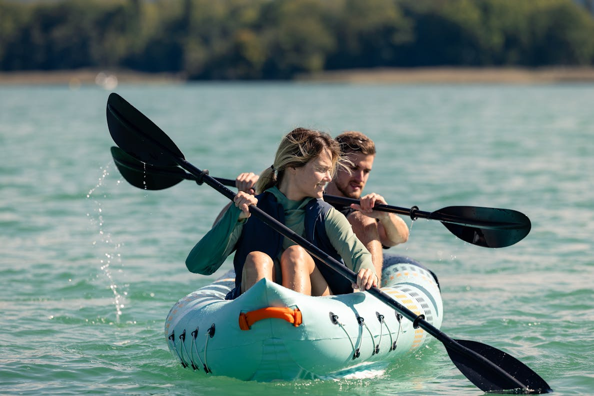 Two people kayaking on the water in Coleman lifejackets