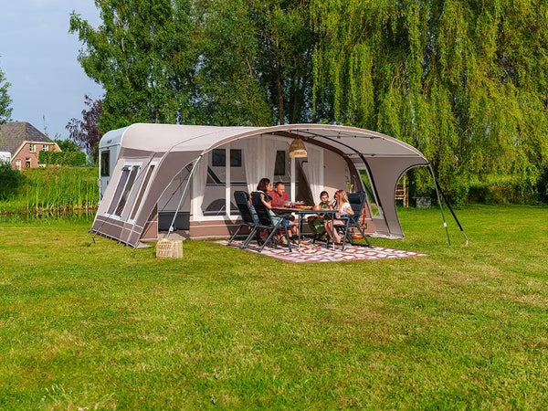Dorema awning pitched on a campsite with camping equipment laid out