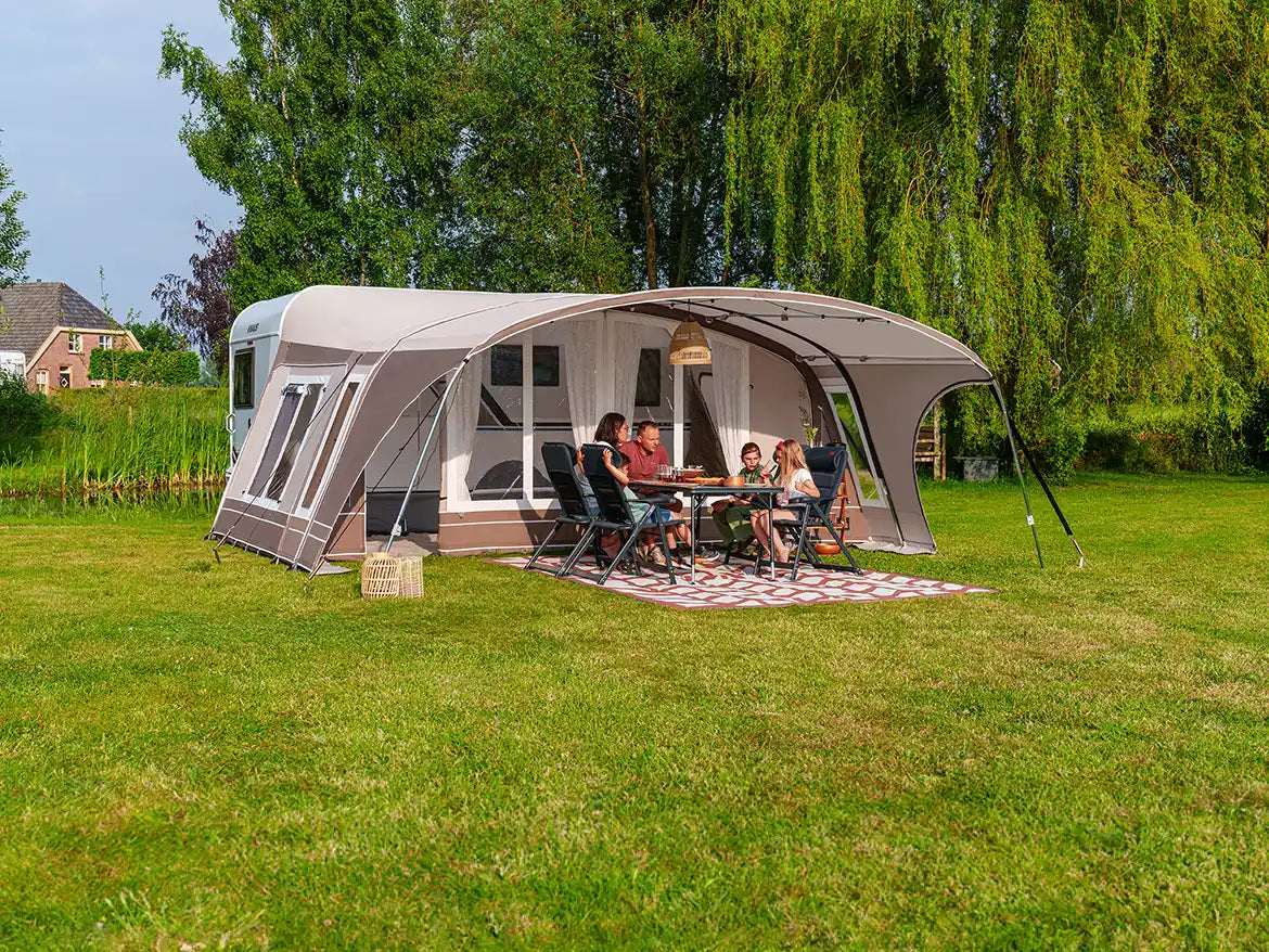 Dorema awning pitched on a campsite with camping equipment laid out