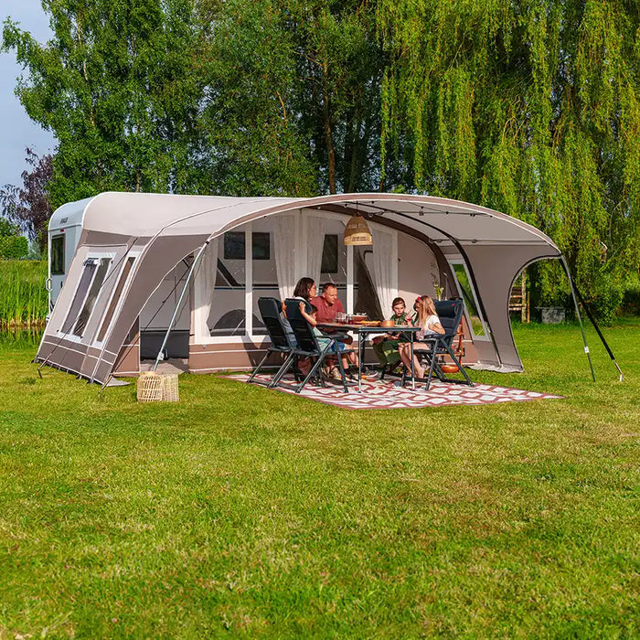 Dorema awning pitched on a campsite with camping equipment laid out
