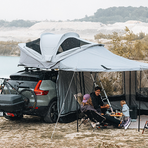 Thule Approach roof tent fully set up with awning by the water