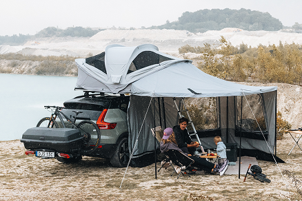 Thule Approach roof tent fully set up with awning by the water