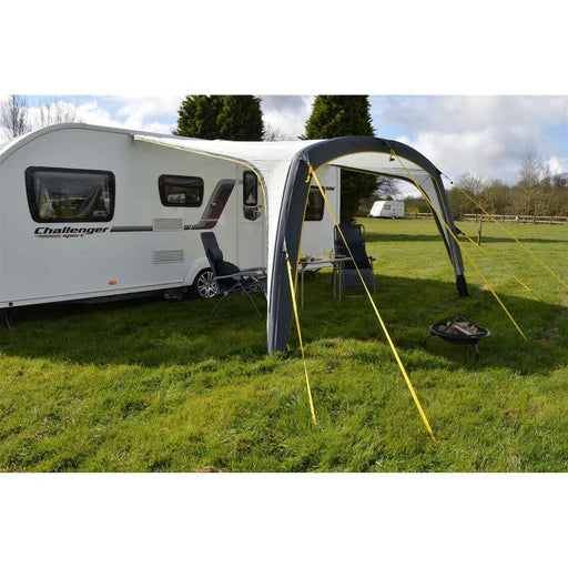Maypole air sun canopy porch awning attached to a caravan with seating set up in daytime sunshine