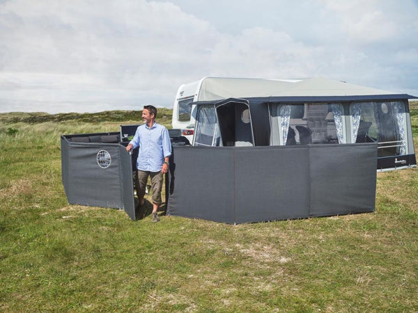Isabella windscreen pitched at a family caravan setup